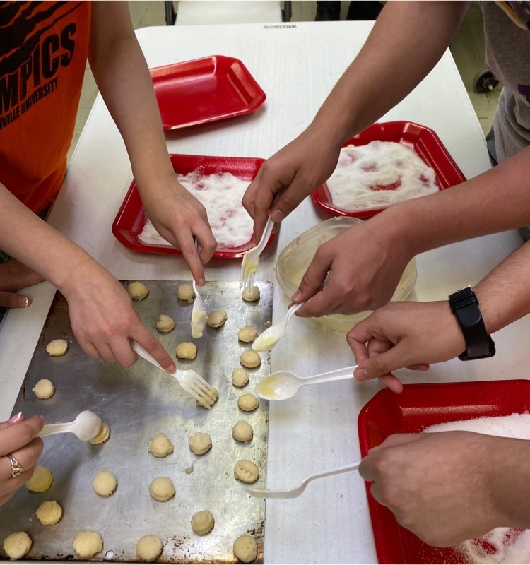 Students preparing the dough to be baked.
